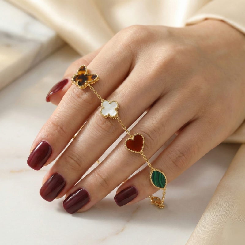 A delicate gold-tone bracelet crafted from rust-resistant stainless steel, adorned with royal green and mother-of-pearl white motifs featuring a butterfly and heart design. It has an adjustable clasp for a perfect fit. - Image 3